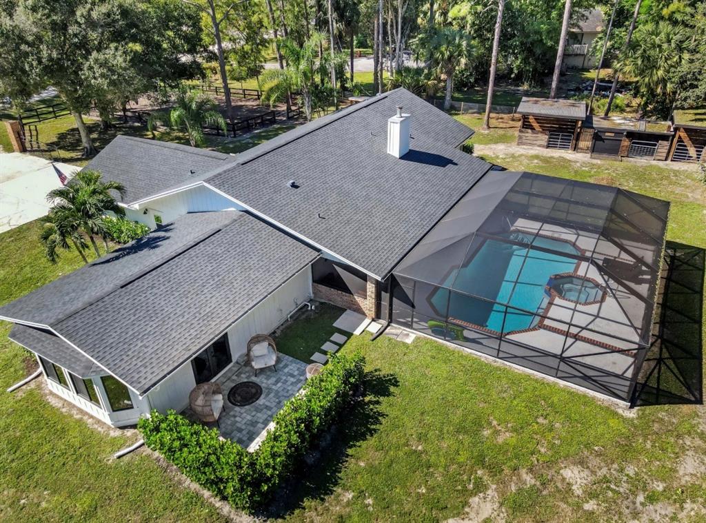 17191 38th Road North Loxahatchee, FL 33470 - Photo 45 of 60 an aerial view of a house with swimming pool and large trees
