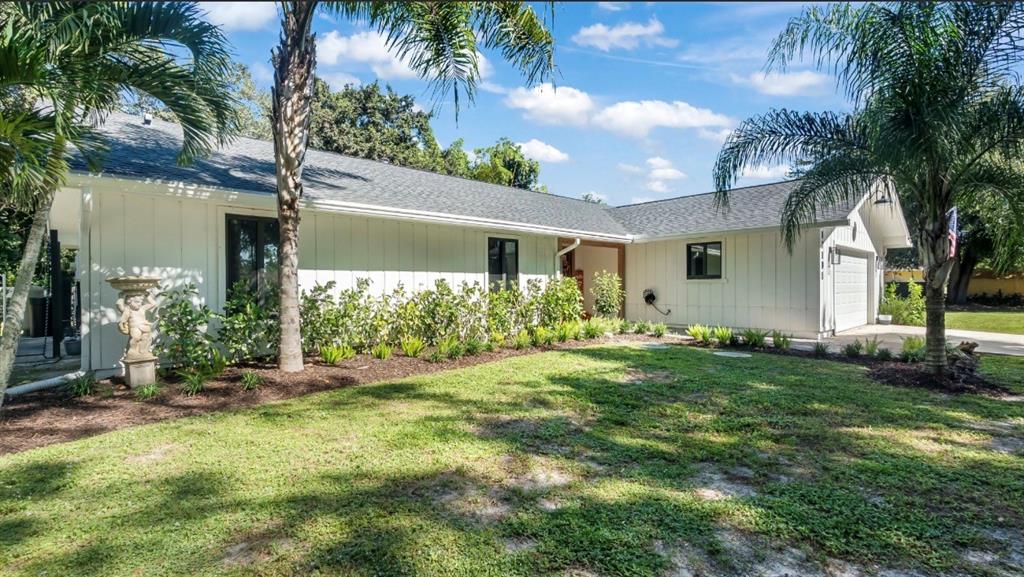 17191 38th Road North Loxahatchee, FL 33470 - Photo 5 of 60 a front view of a house with garden