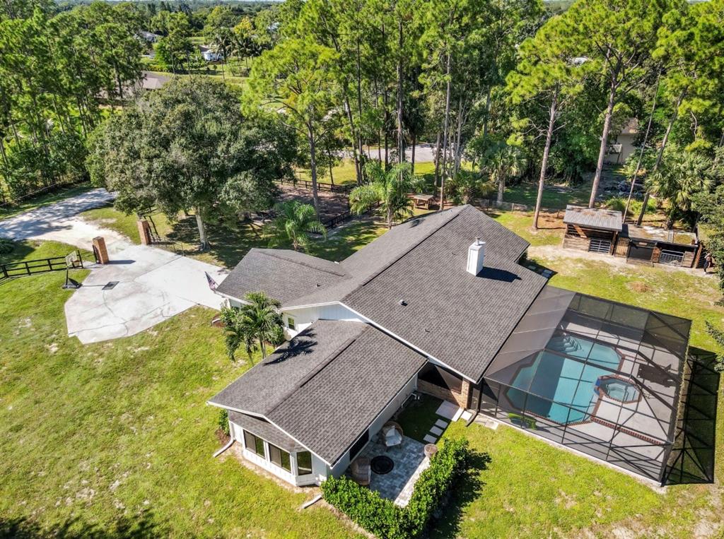 17191 38th Road North Loxahatchee, FL 33470 - Photo 52 of 60 an aerial view of a house with swimming pool and large trees