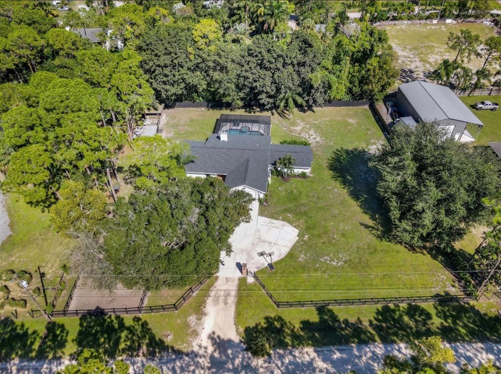 17191 38th Road North Loxahatchee, FL 33470 - Photo 55 of 60 an aerial view of a house with a yard and lake view