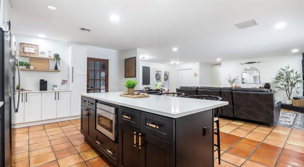 17191 38th Road North Loxahatchee, FL 33470 - Photo 8 of 60 a large kitchen with kitchen island a sink a stove a refrigerator and a dining table with wooden floor