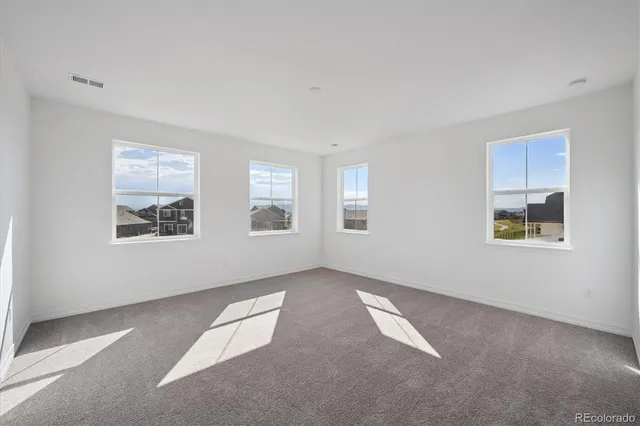 a view of an empty room with windows