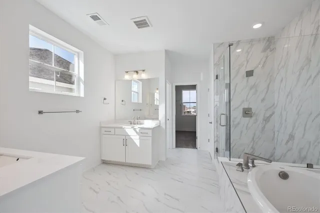 a bathroom with a tub sink and mirror
