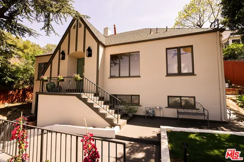 a view of a house with wooden fence