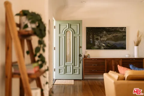 a view of a hallway with wooden floor and staircase