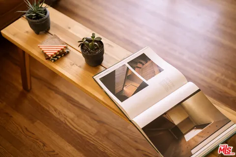 a view of a livingroom with workspace and a window