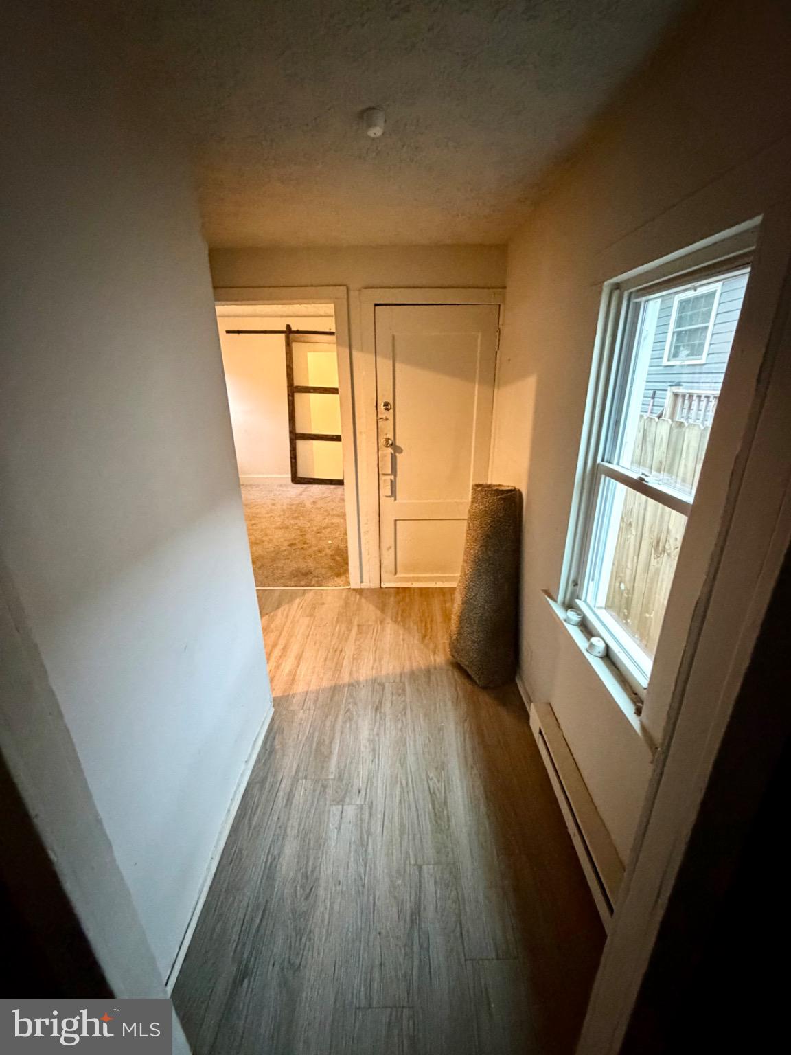 528 Fremont Street Winchester, VA 22601 - Photo 8 of 16 a view of an empty room with wooden floor and a window