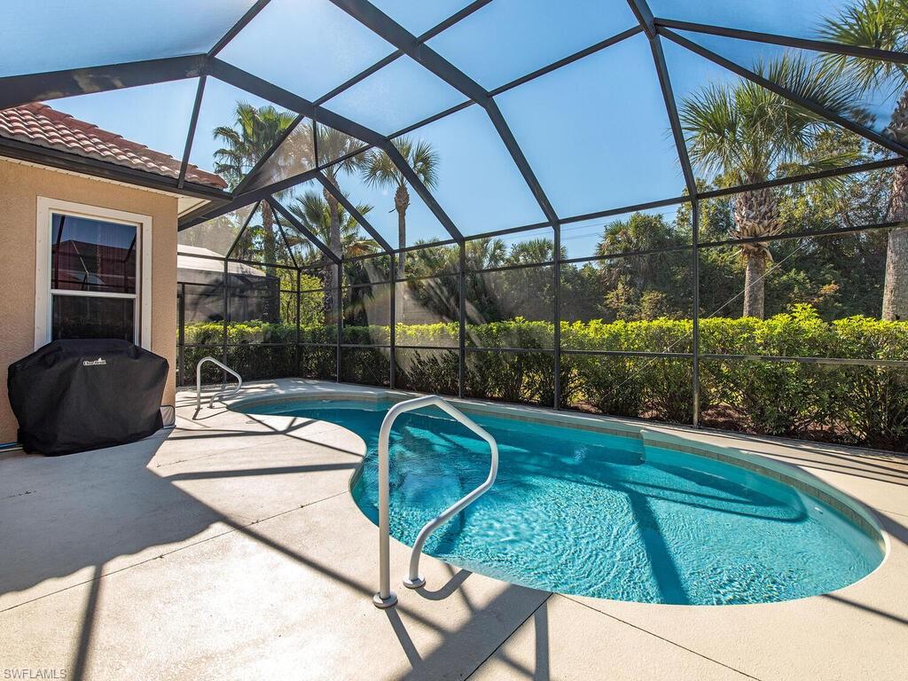 7896 Founders Circle Naples, FL 34104 - Photo 11 of 12 a view of swimming pool with a patio and a garden