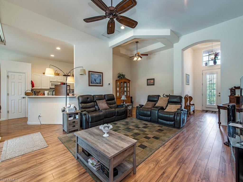 7896 Founders Circle Naples, FL 34104 - Photo 2 of 12 a living room with furniture and a wooden floor