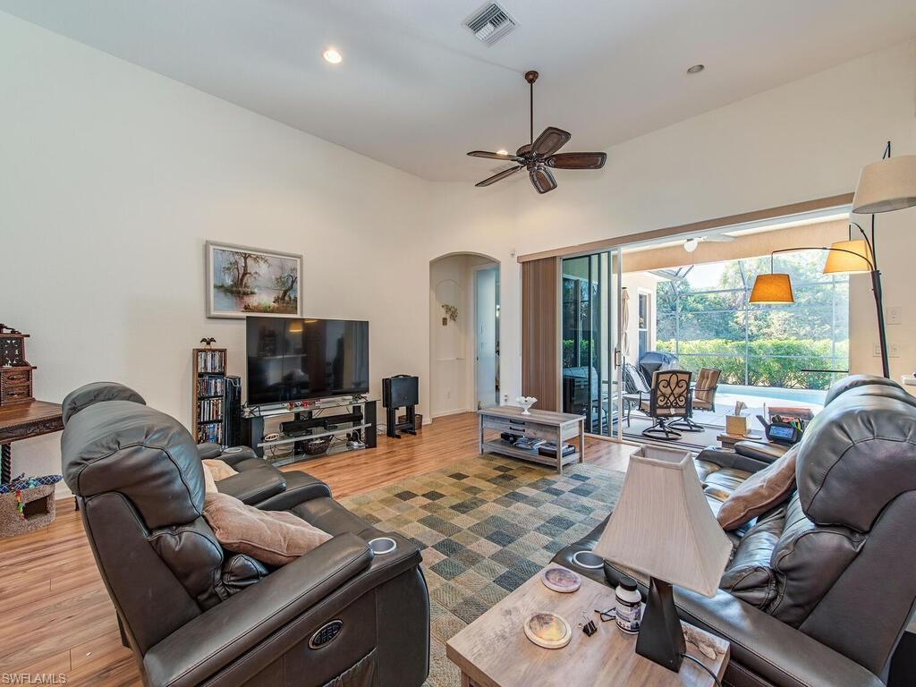 7896 Founders Circle Naples, FL 34104 - Photo 3 of 12 a living room with furniture and a flat screen tv
