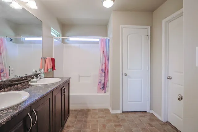 a bathroom with a sink vanity tub and shower