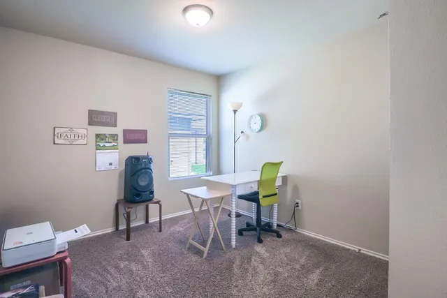 a view of a dining room with furniture and a window