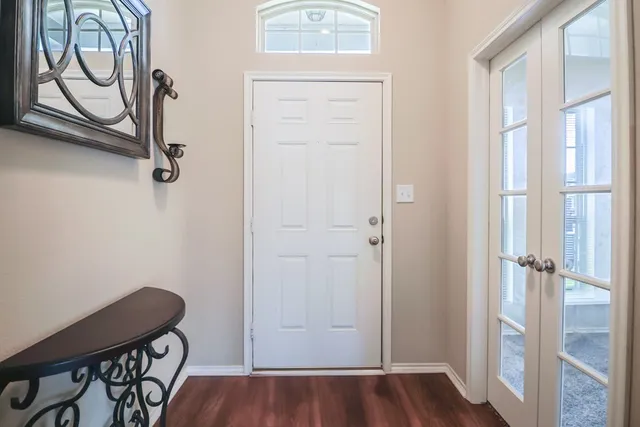 a view of front door with wooden floor