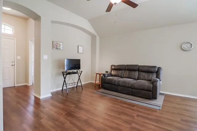 a living room with furniture and a flat screen tv