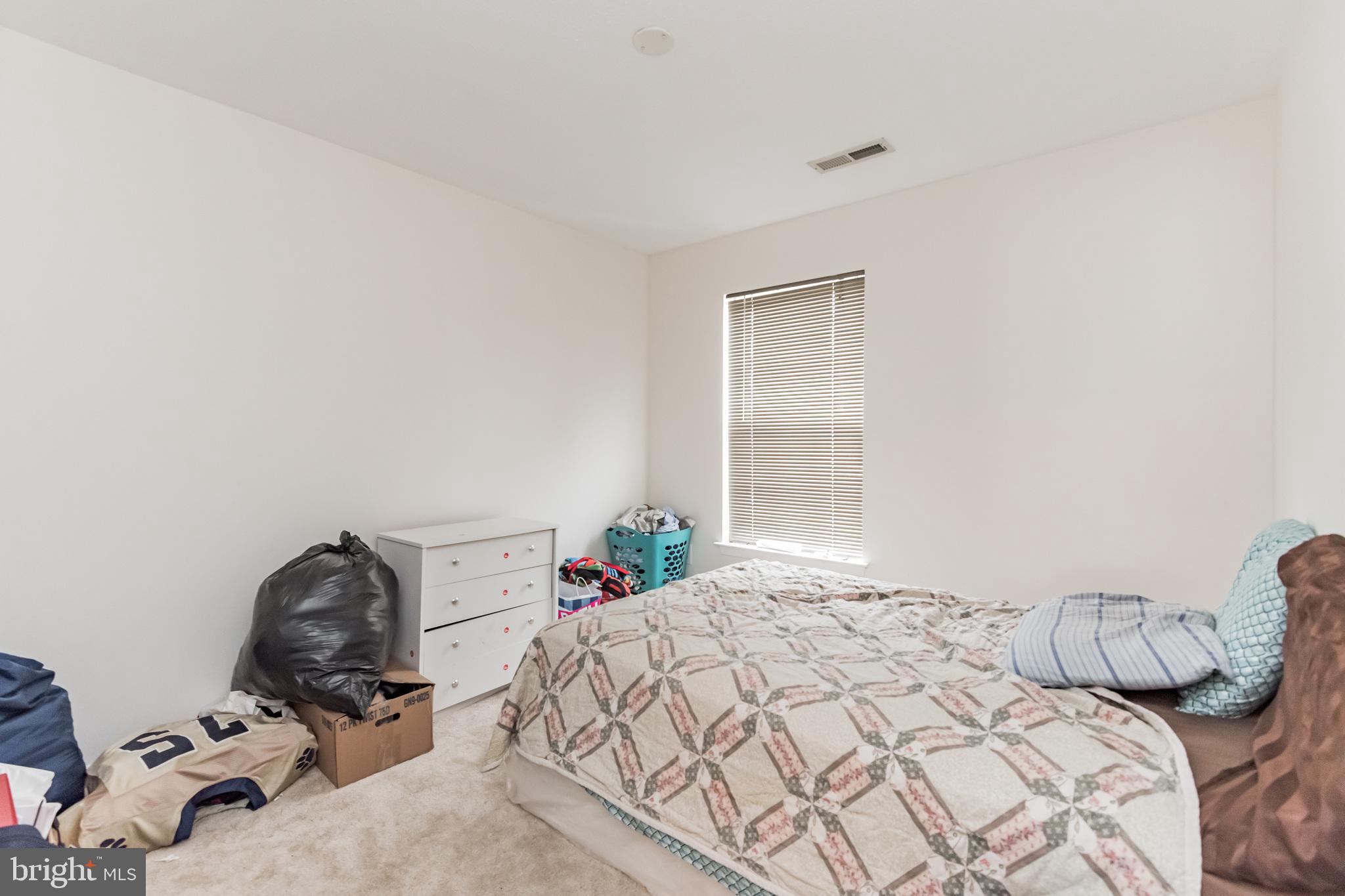 836 Lowe Road Middle River, MD 21220 - Photo 18 of 30 a bedroom with a bed and a window