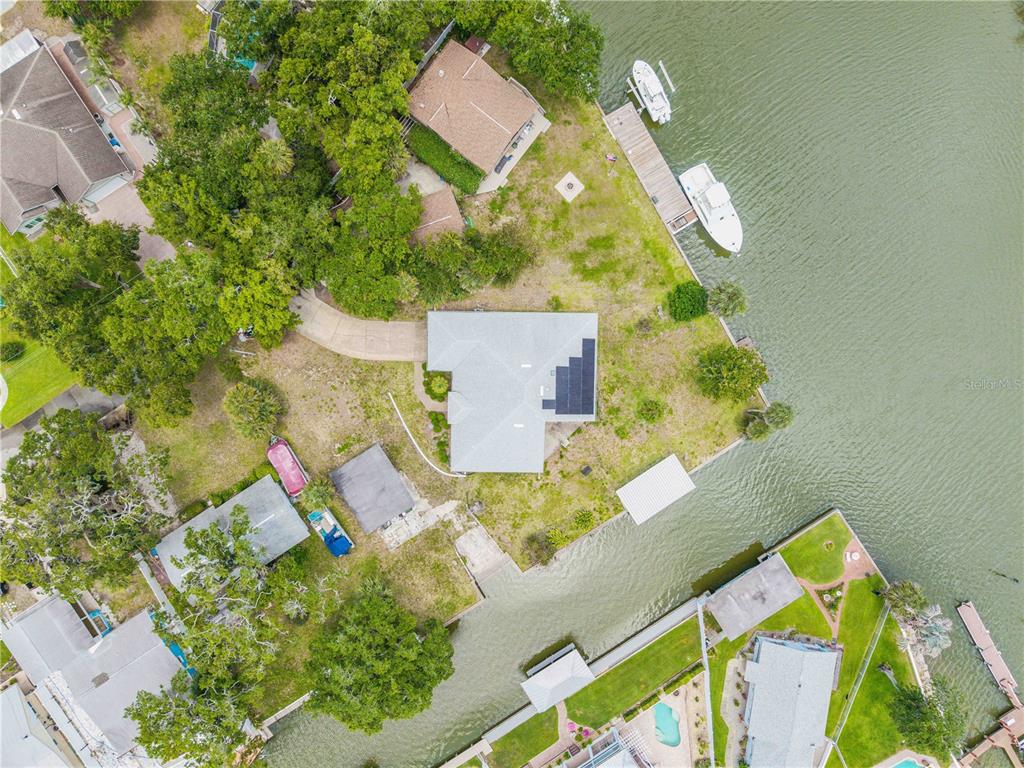 192 Azalea Road Edgewater, FL 32141 - Photo 91 of 94 an aerial view of a house with a yard and greenery