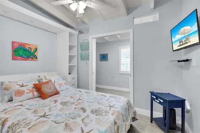 a living room with furniture a chandelier and a wooden floor