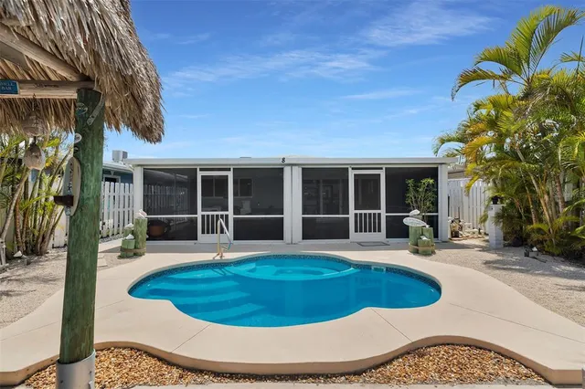 a view of a house with swimming pool and sitting area