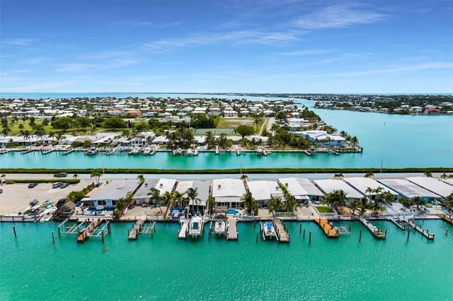 a view of a lake with lawn chairs