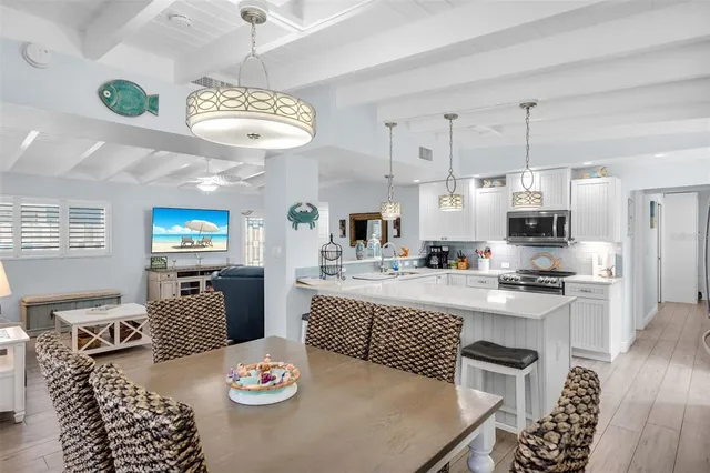 a kitchen with stainless steel appliances kitchen island granite countertop a sink a stove and a refrigerator