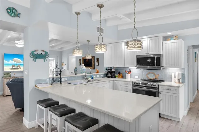 a kitchen with a sink stove and cabinets