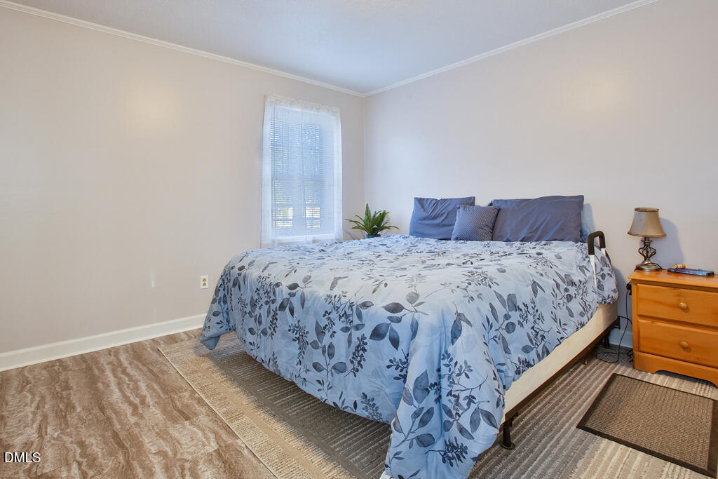 1727 Pinecrest Road Henderson, NC 27536 - Photo 11 of 14 a bedroom with a bed and a window