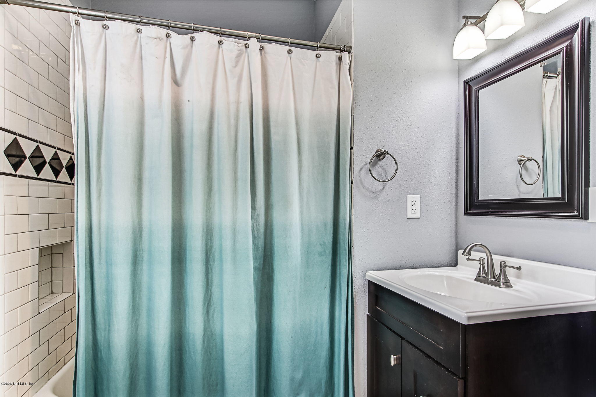 1292 Wolfe Street Jacksonville, FL 32205 - Photo 27 of 38 a bathroom with a sink and a mirror