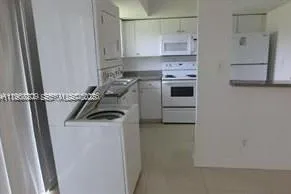 a kitchen with a stove and a refrigerator