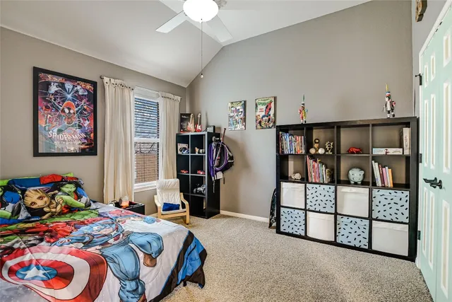 a bedroom with bed and a chandelier