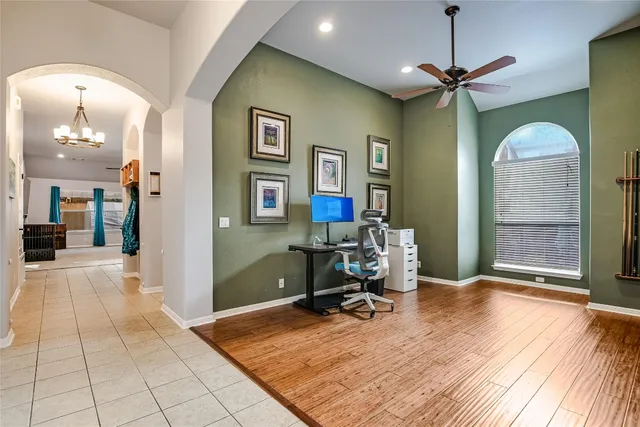 a view of a livingroom with wooden floor and a chandelier