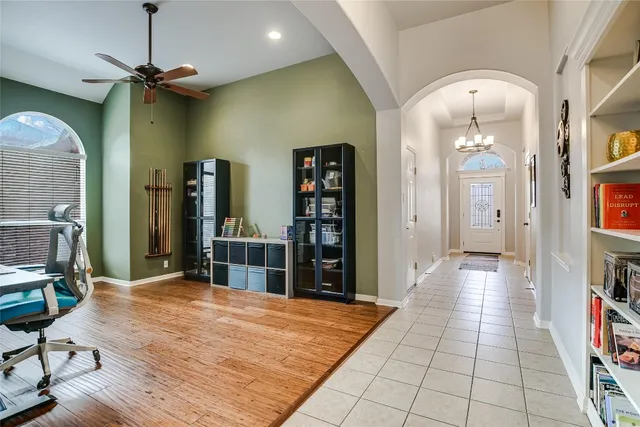 a view of a hallway with wooden floor and furniture