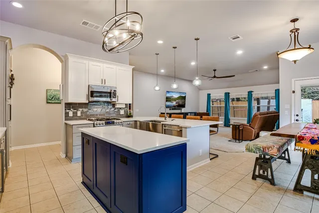 a kitchen with stove a sink and refrigerator