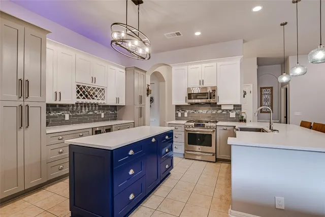 a kitchen with a stove oven and cabinets