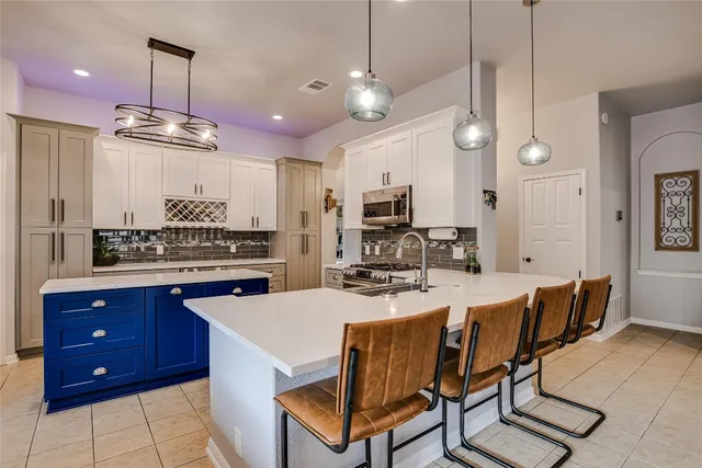 a kitchen with a stove a sink and a refrigerator
