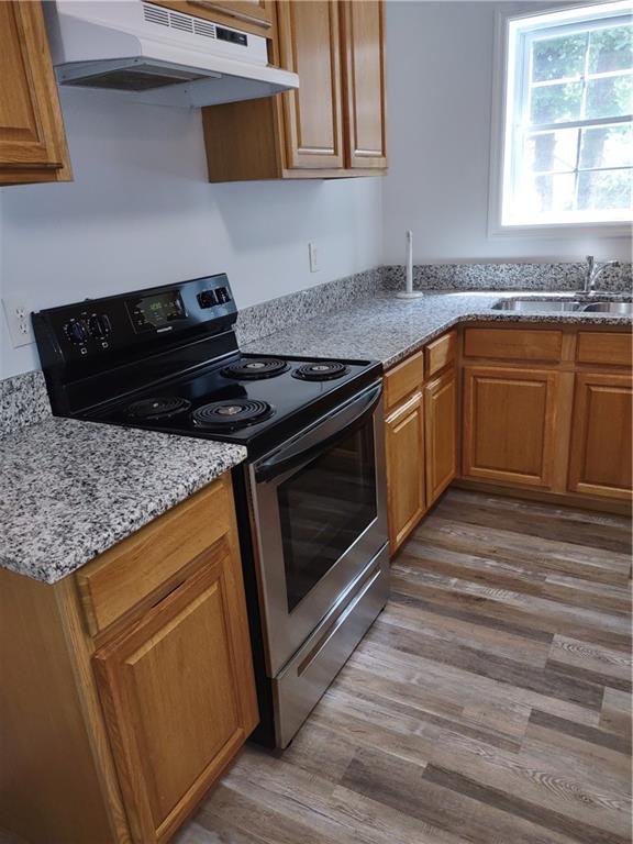 7675 Campground Road, Unit A Cumming, GA 30040 - Photo 2 of 13 a kitchen with granite countertop a sink stainless steel appliances and cabinets