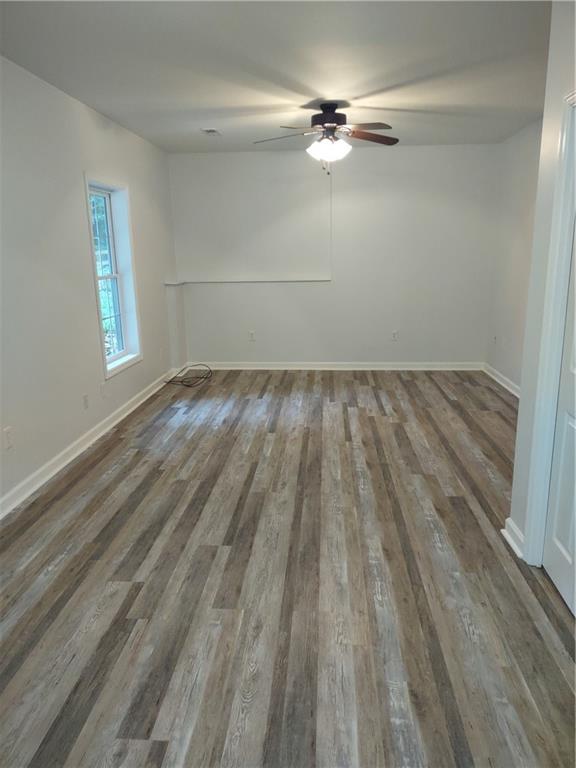 7675 Campground Road, Unit A Cumming, GA 30040 - Photo 8 of 13 wooden floor in an empty room with a window