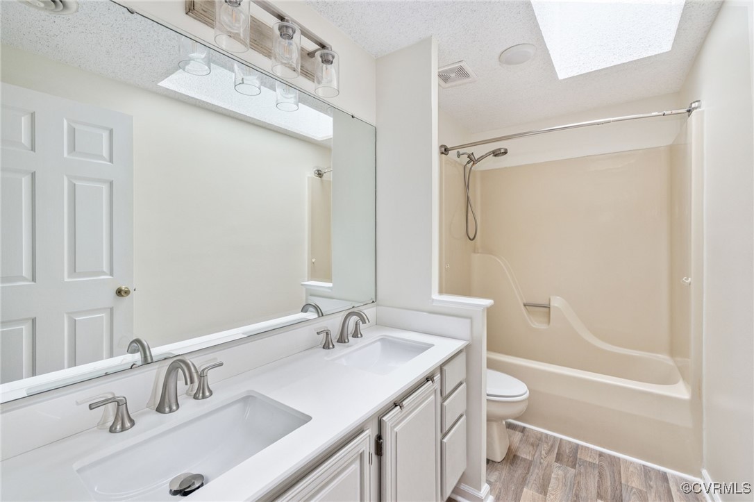 9645 Benbow Road North Chesterfield, VA 23235 - Photo 30 of 44 A full hall bath with a skylight, double vanity, a