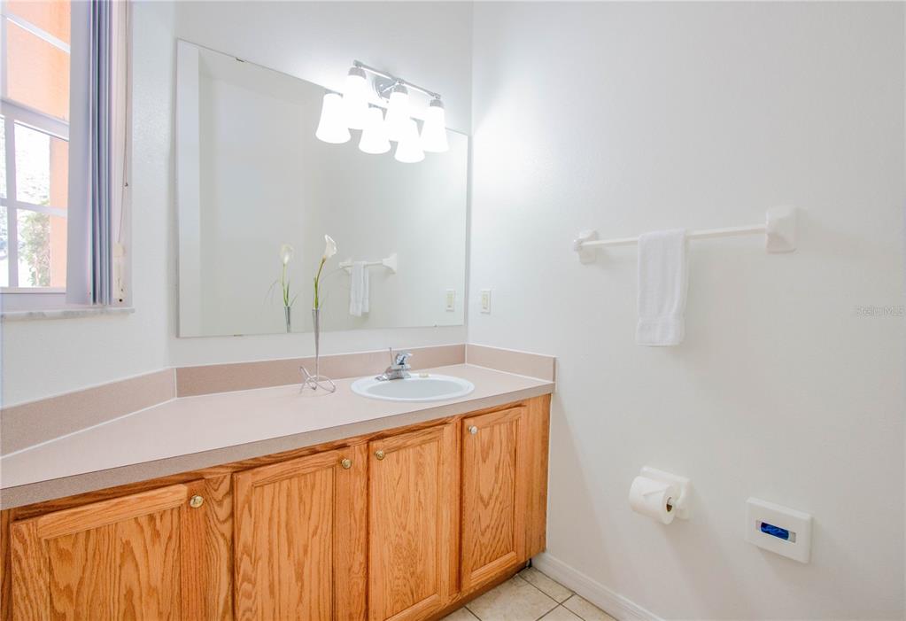1103 Park Ridge Circle Kissimmee, FL 34746 - Photo 21 of 72 a bathroom with a sink and a mirror