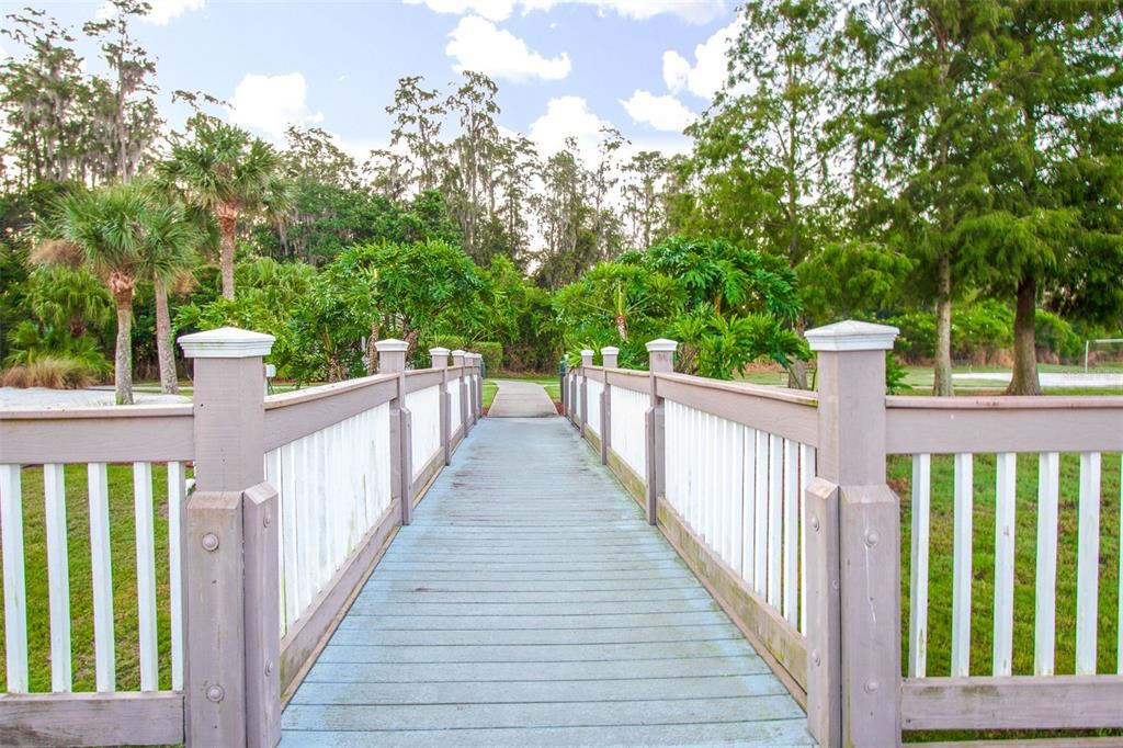 1103 Park Ridge Circle Kissimmee, FL 34746 - Photo 28 of 72 a view of a house with large trees and wooden fence