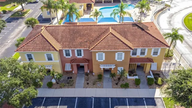 a view of a white house with a yard