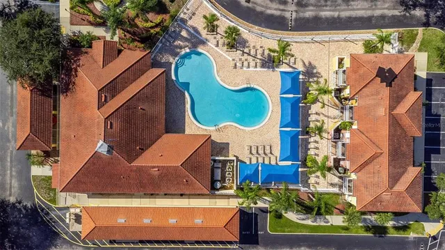 a front view of house with yard and swimming pool