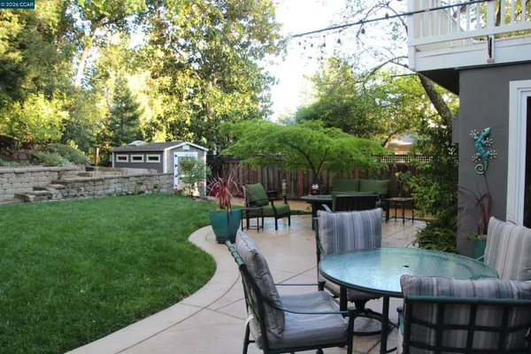 a view of a patio with a table and chairs
