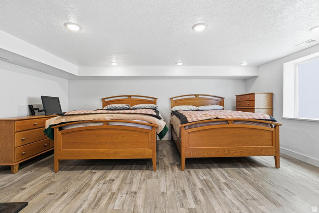 916 North Bonneville Road Preston, ID 83263 - Photo 8 of 37 Bedroom with light wood-style flooring and a textured ceiling