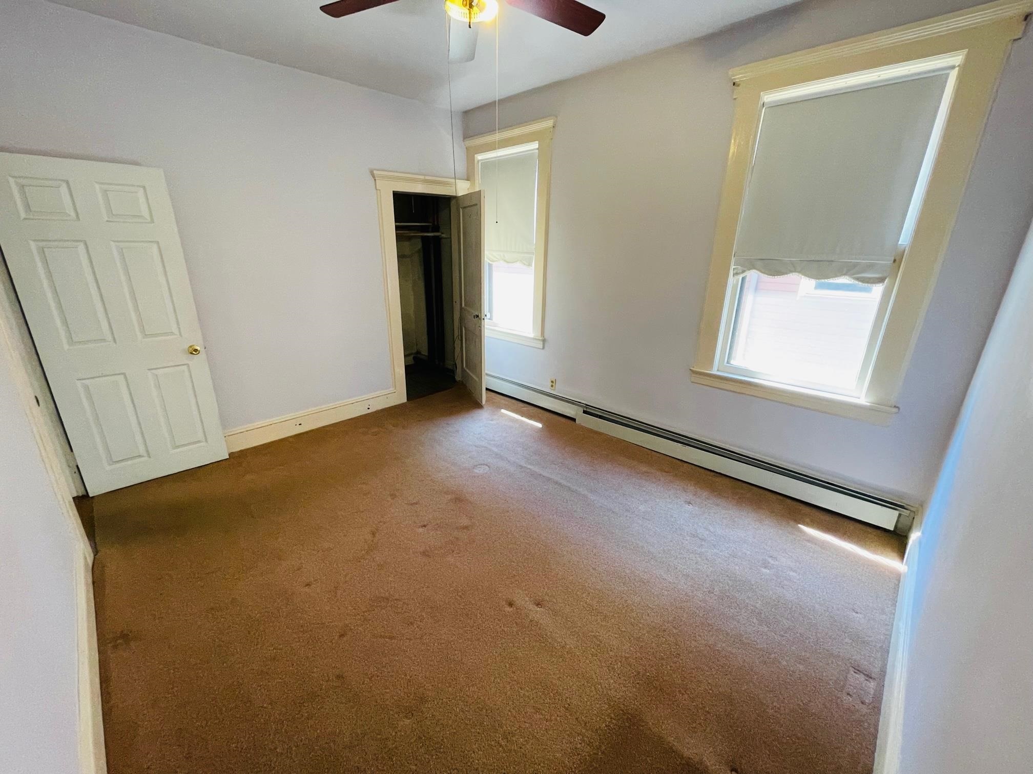 252 Murray Street, Unit 2 Elizabeth, NJ 07202 - Photo 11 of 14 an empty room with a bathroom and a mirror