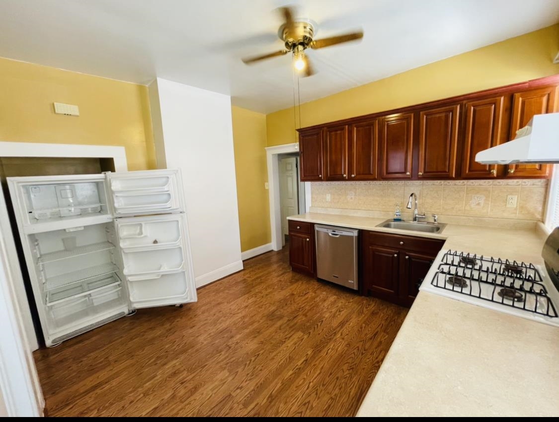 252 Murray Street, Unit 2 Elizabeth, NJ 07202 - Photo 3 of 14 a kitchen with stainless steel appliances a stove and a refrigerator