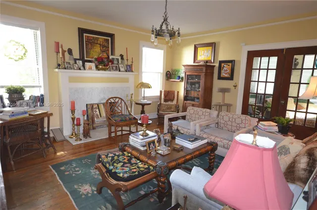 a living room with furniture a fireplace and a table