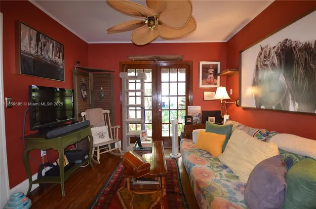 a living room with furniture a lamp and a floor to ceiling window