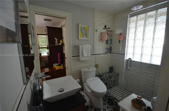 a bathroom with a toilet sink and shower