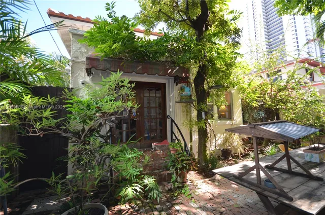a view of a house with a yard and sitting area