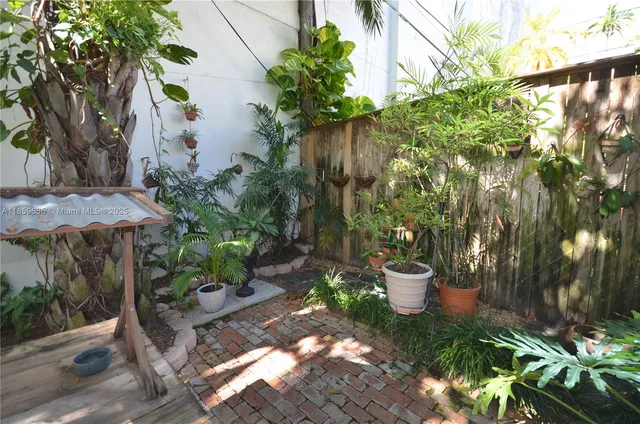 a view of a backyard with plants and garden